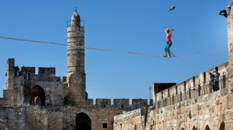 Female U.S. Daredevil crosses ancient Jerusalem towers on slackline